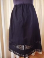 black cotton petticoat embellished with lace trims and pintucks