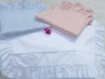 baby pink cotton pillowcases adorned with ruffles all around them