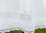 white cotton petticoat adorned with lace trims and pin tucks
