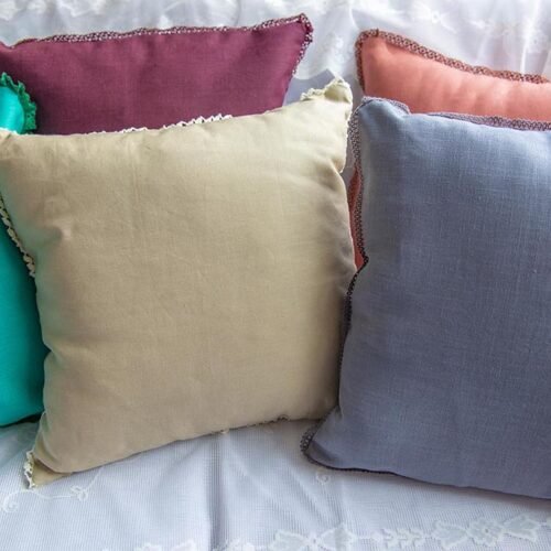 multi-coloured linen cushion covers with edging lace trims