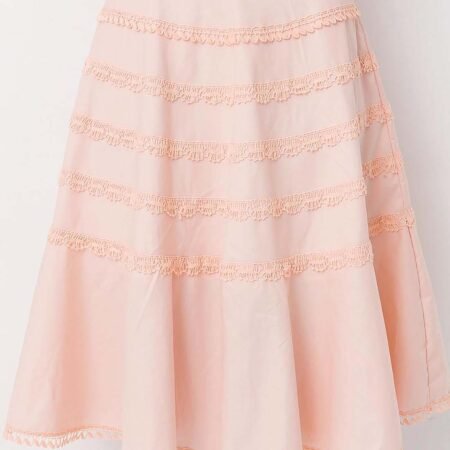 Model wearing a gorgeous peach cotton flounce skirt lavishly adorned with bobbin lace trims