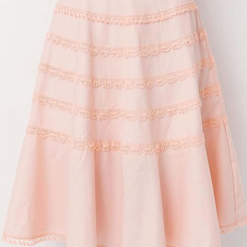 Model wearing a gorgeous peach cotton flounce skirt lavishly adorned with bobbin lace trims